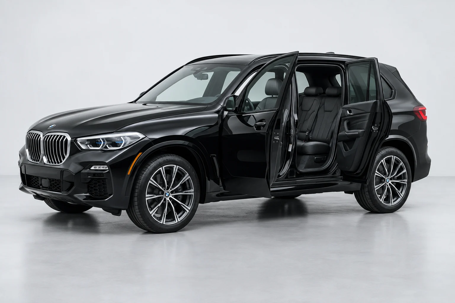 Black BMW X5 with its doors open. Choose a point to explore our detailing care.