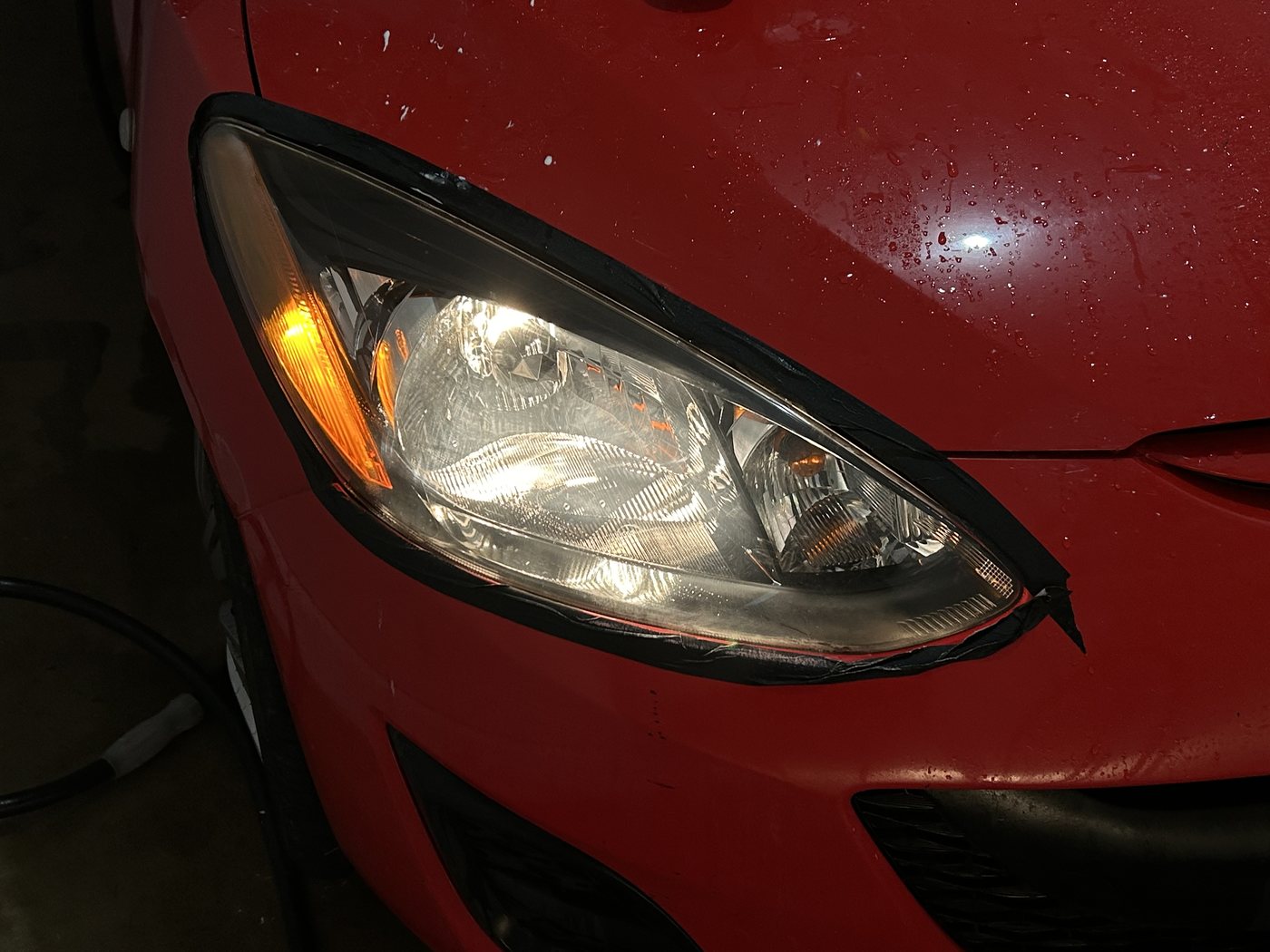 The same Mazda 3 headlight after restoration, the projector and reflector crisp behind clear plastic