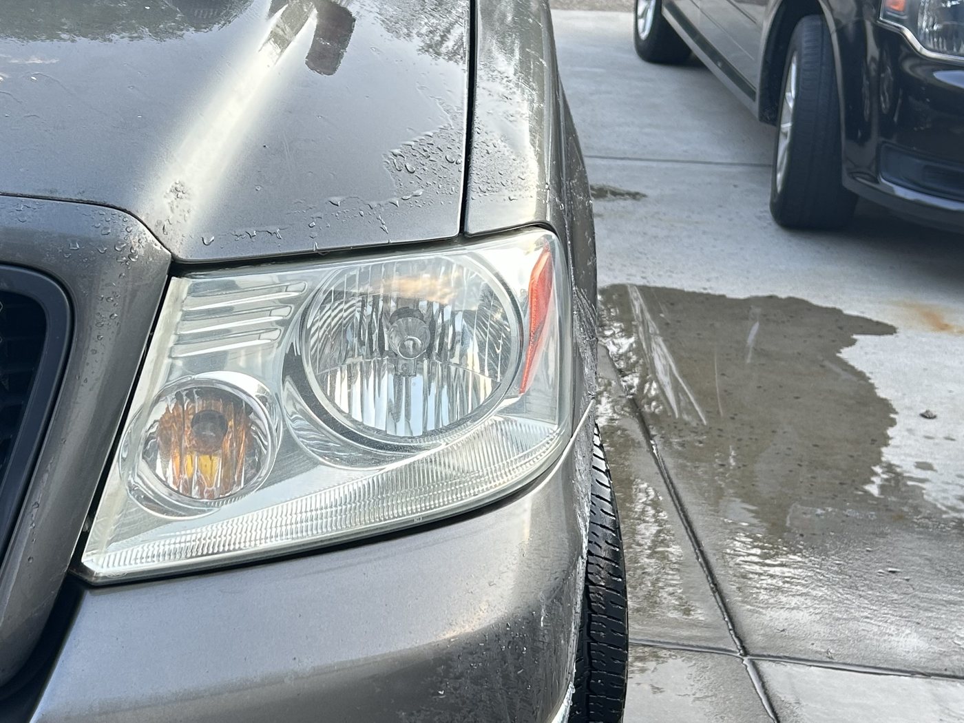 The same Ford F-150 headlight after restoration, the lens clear and the reflector sharp